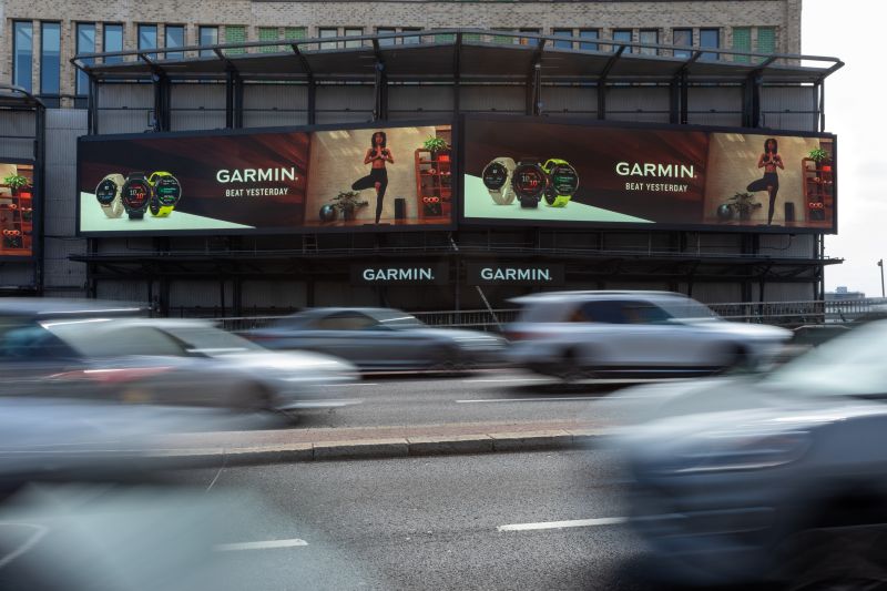 A OOH site on a busy road with cars rushing past