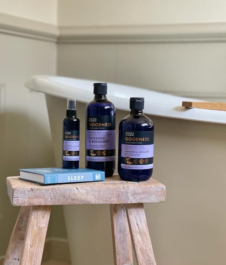Baylis & Harding soaps on a stand by the bath tub
